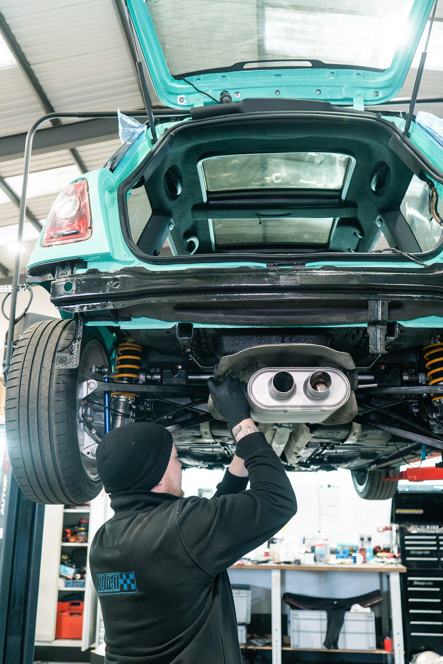 ragazzon exhaust being installed on a GEN 2 MINI R56