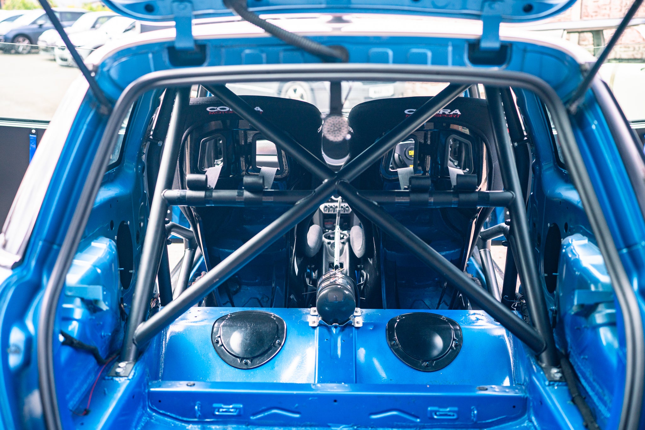 Carousel of images of an R56 MINI getting stripped down ready for painting and then it freshly painted on the ramp at Lohen. AP racing big brake kit fitted and carbon panels.