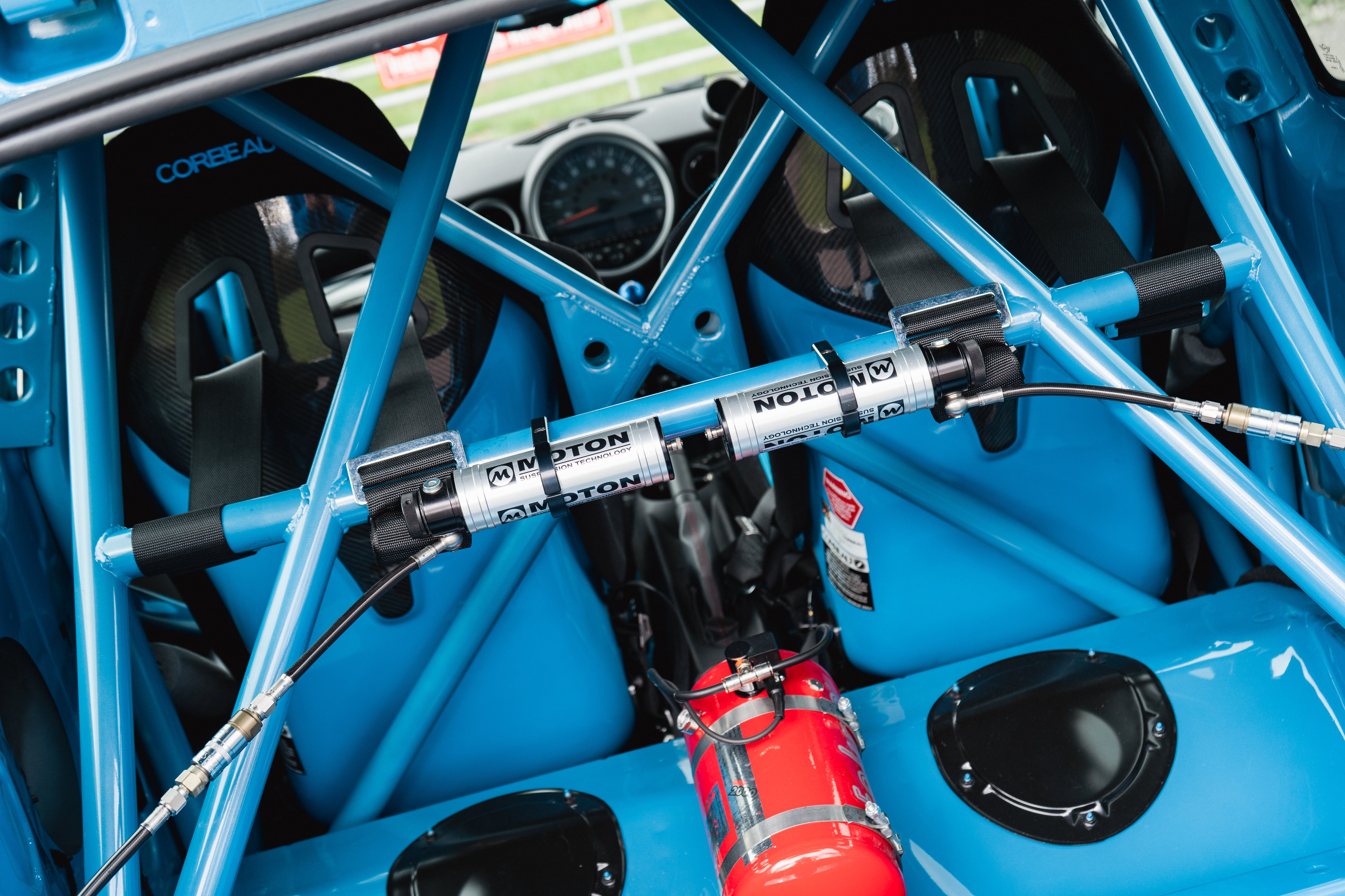 custom roll cage in a MINI R56 JCW with Moton suspension damper controls mounted on the cage. Corbeau seats visable from the back.