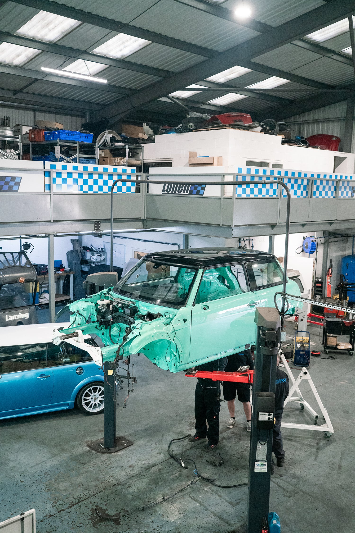 Carousel of images of an R56 MINI getting stripped down ready for painting and then it freshly painted on the ramp at Lohen. AP racing big brake kit fitted and carbon panels.